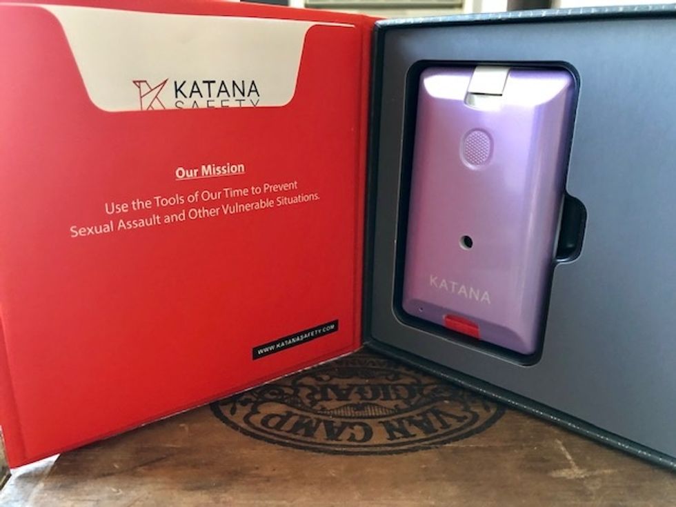 A photo of lavender colored Katana in the box, which sends off an alarm at 125 decibels, about the sound of a front seat at a concert