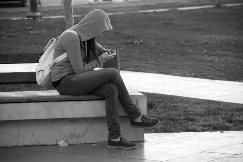 Photo of a young woman on a smartphone, as a new study suggests that heavy use of social media may be one reason for an increase in mental health issue among teens and young adults