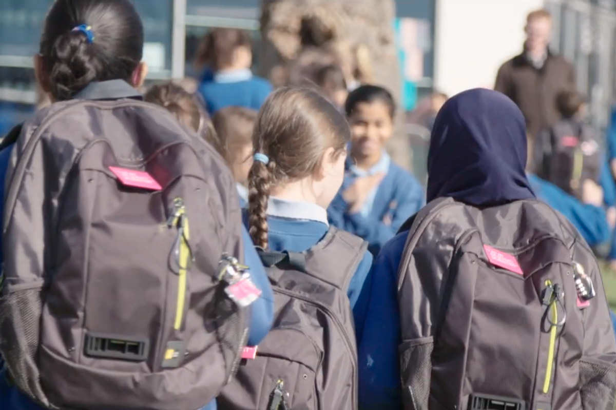 Photo of schoolchildren wearing Dyson air quality-monitoring backpack