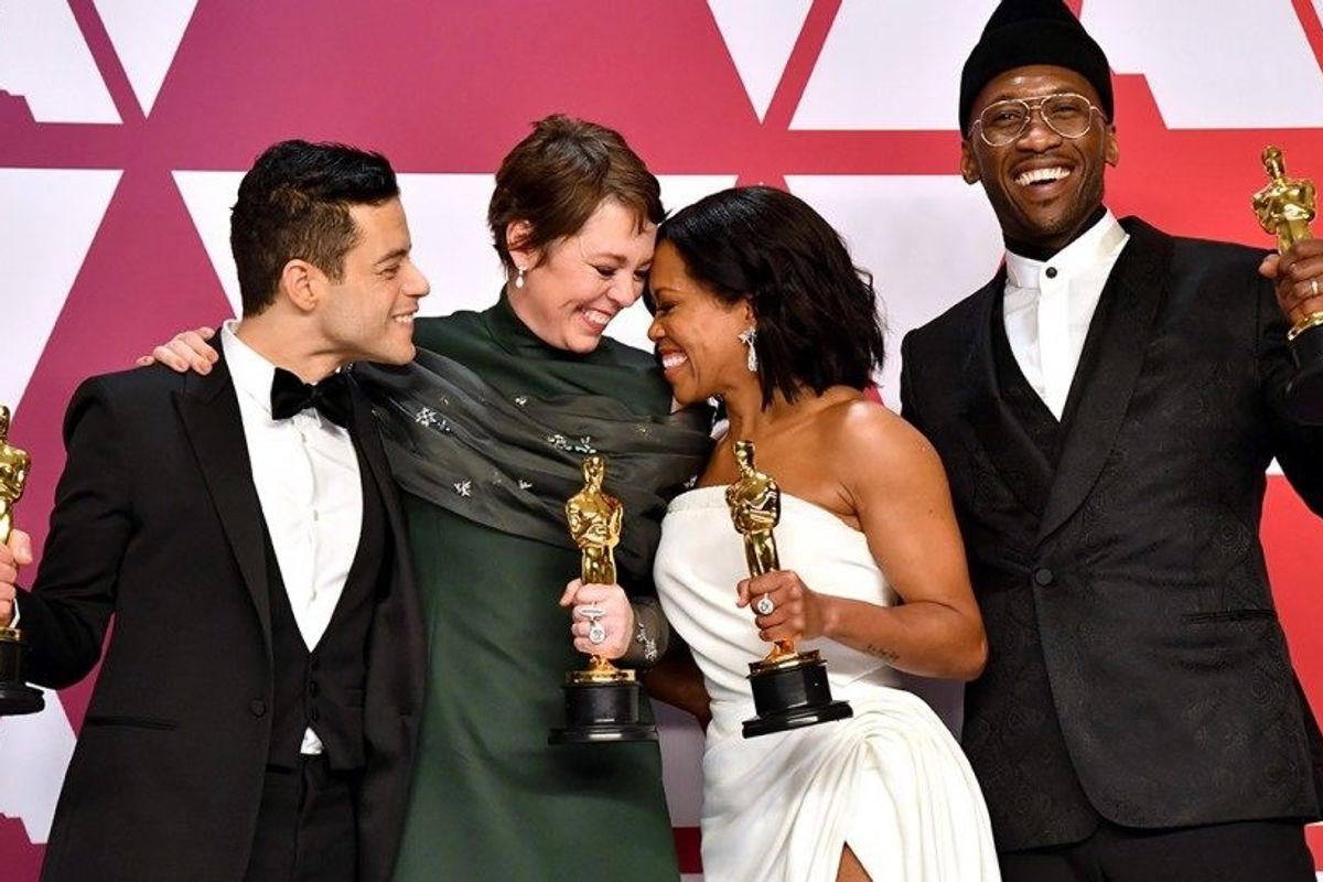 Oscar winners smiling and holding awards