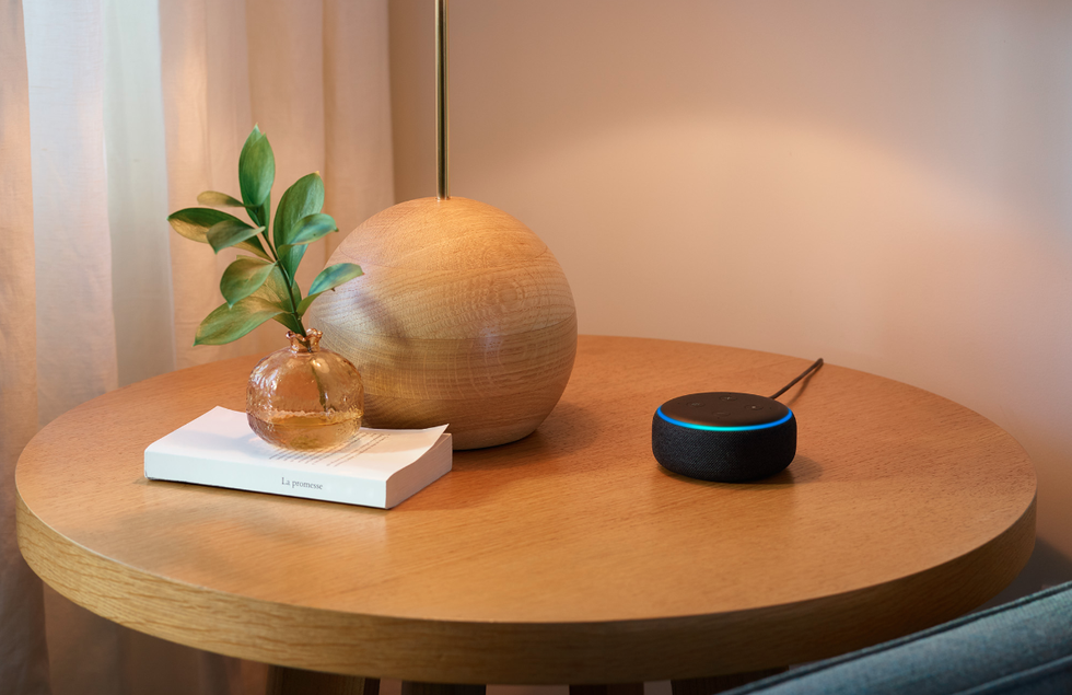 Photo of an Amazon Echo Dot on a bedside table