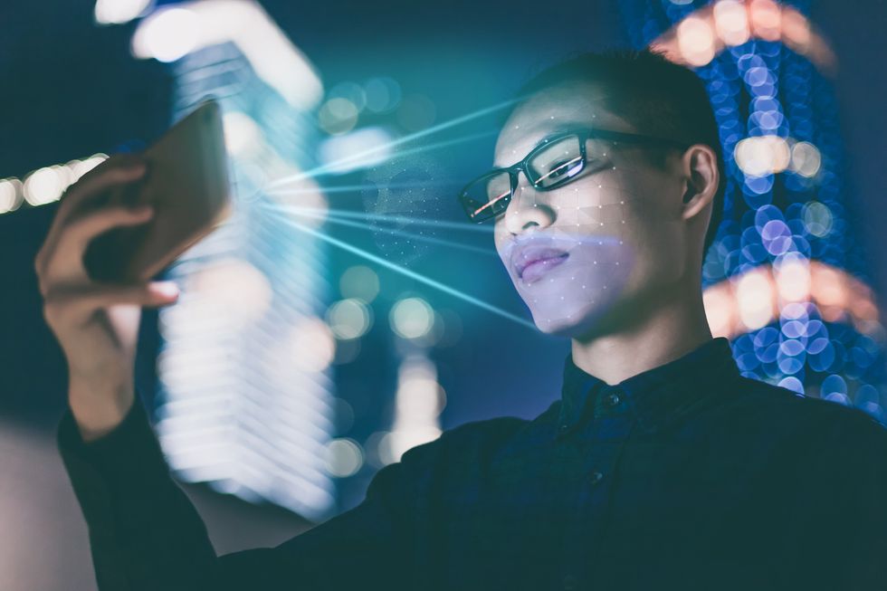 Photo of man using a smartphone's facial recognition system