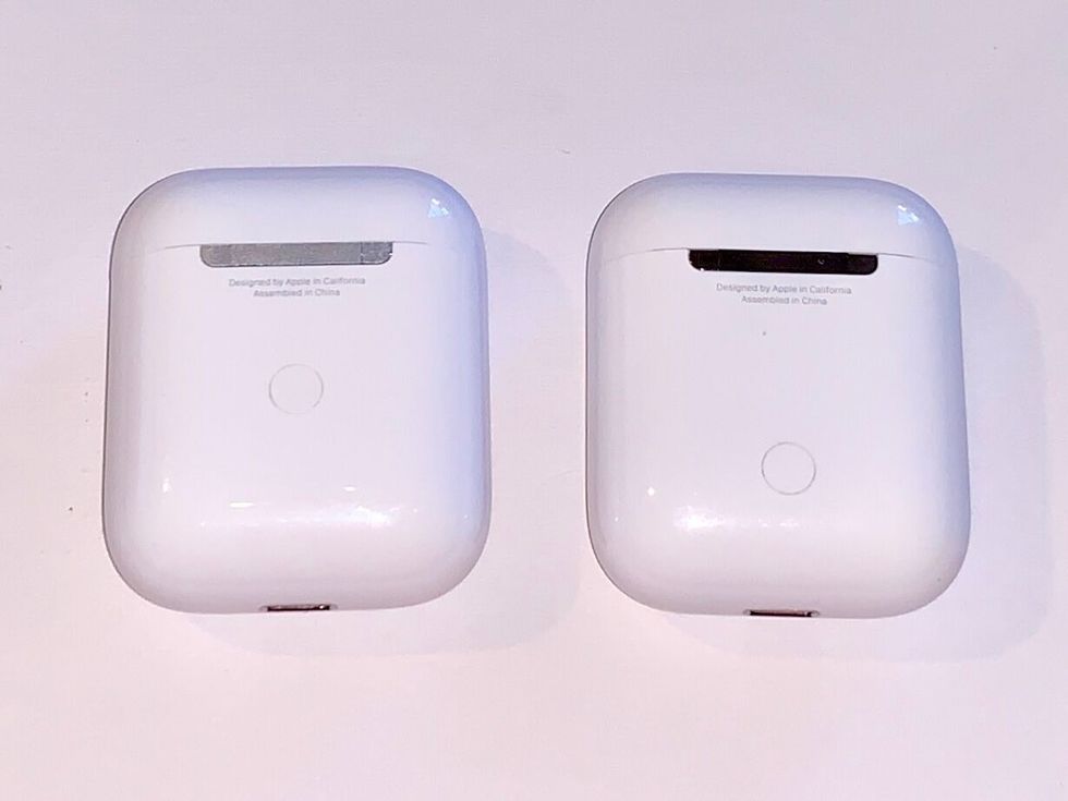 A photo of the back of the new AirPods 2, which you can charge through the Lightning port is you're away from your Qi mat