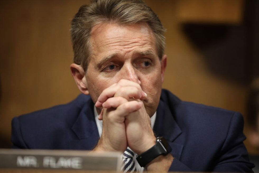 Jeff Flake refuses to look at two women who confront him in elevator after he announces support for Kavanaugh.