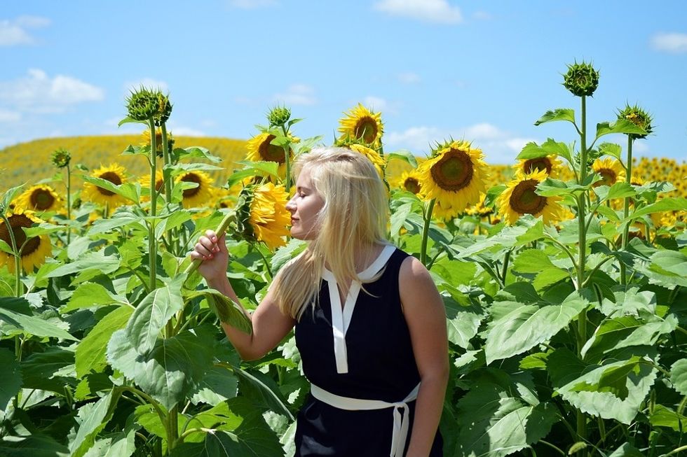 girl in sunflower field summertime