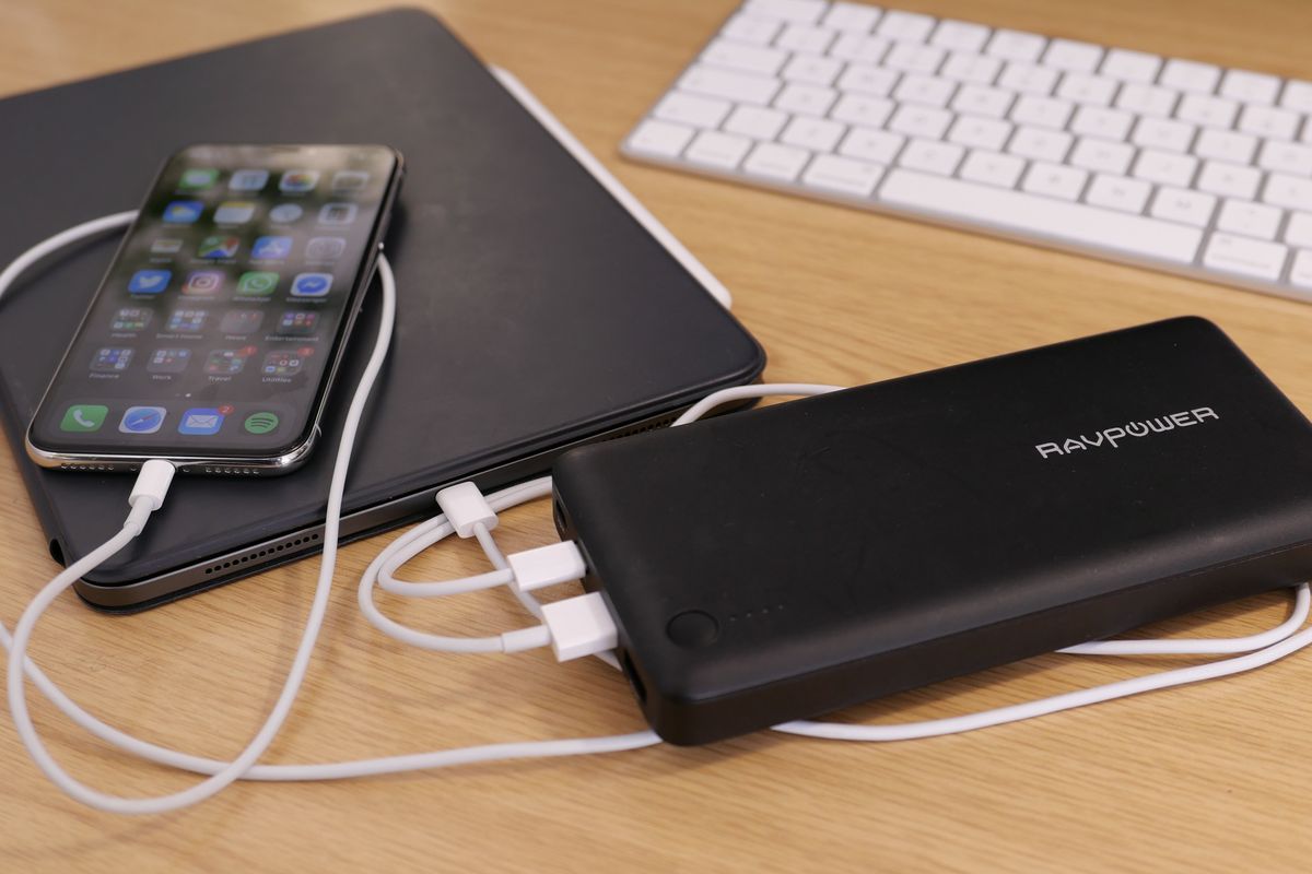 Photo of a power bank charging an iPad Pro and iPhone X