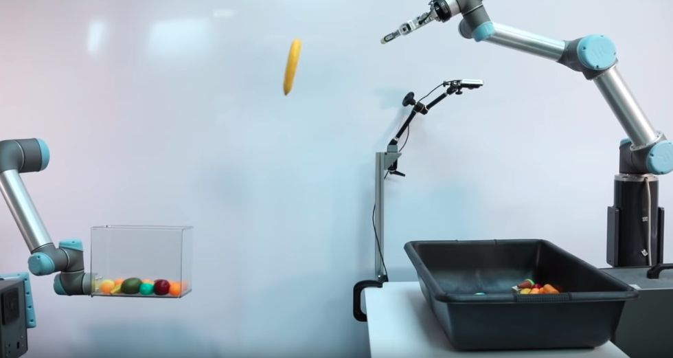 Image showing a Google-built robot throwing an object into a box