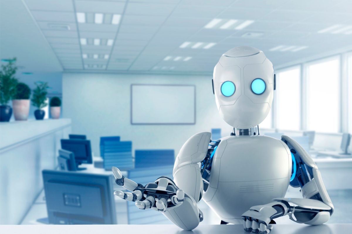 Image of a humanoid robot sat at a desk