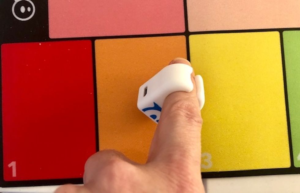 A photo of a Sphero Specdrum ring playing on a keyboard