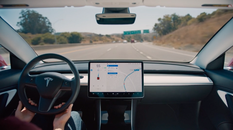 Photo showing a Tesla Model 3 driving with Autopilot enabled