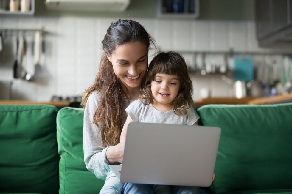 A photo of a mom spending time online with her child