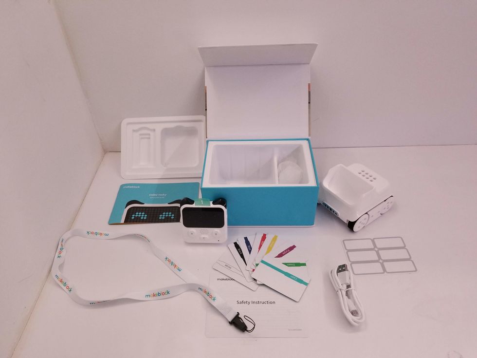 A photo of everything in the Codey Rocky box including the controller, chassis, color cards and a charger