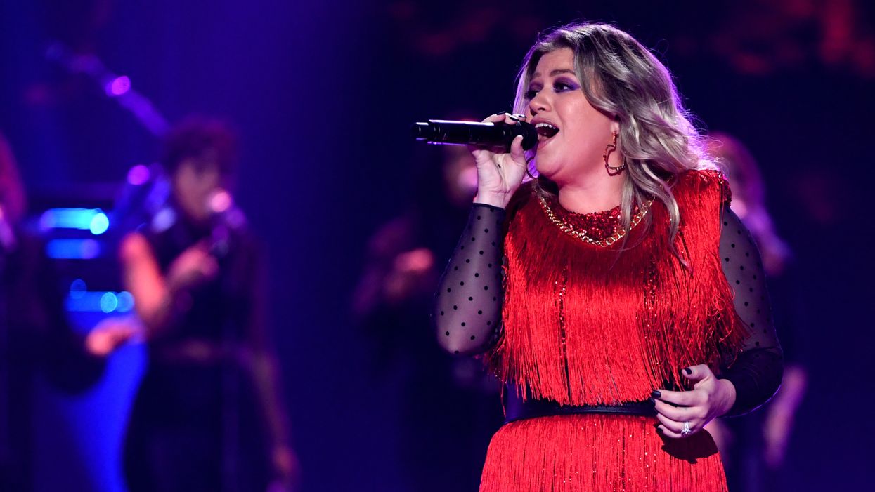Kelly Clarkson gets emotional when husband surprises her during concert