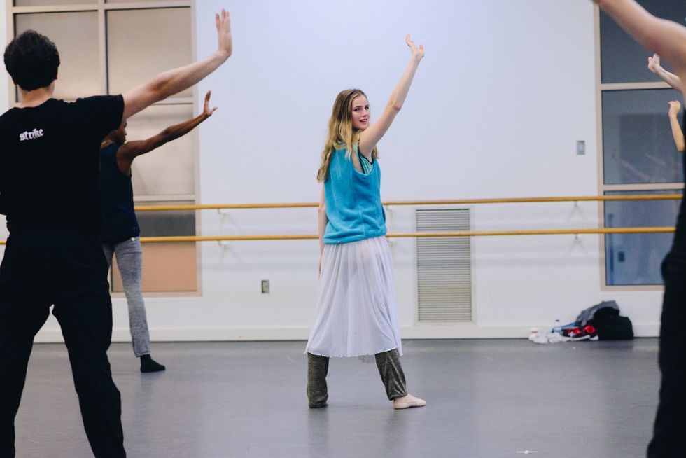 Sage Humphries leads a rehearsal at the Boston Ballet studios, demonstrating one hand up