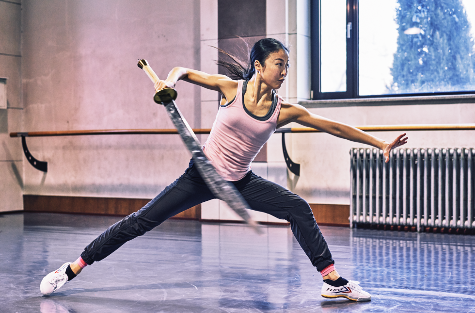 PeiJu Chien-Pott wields a sword in a wide lunge