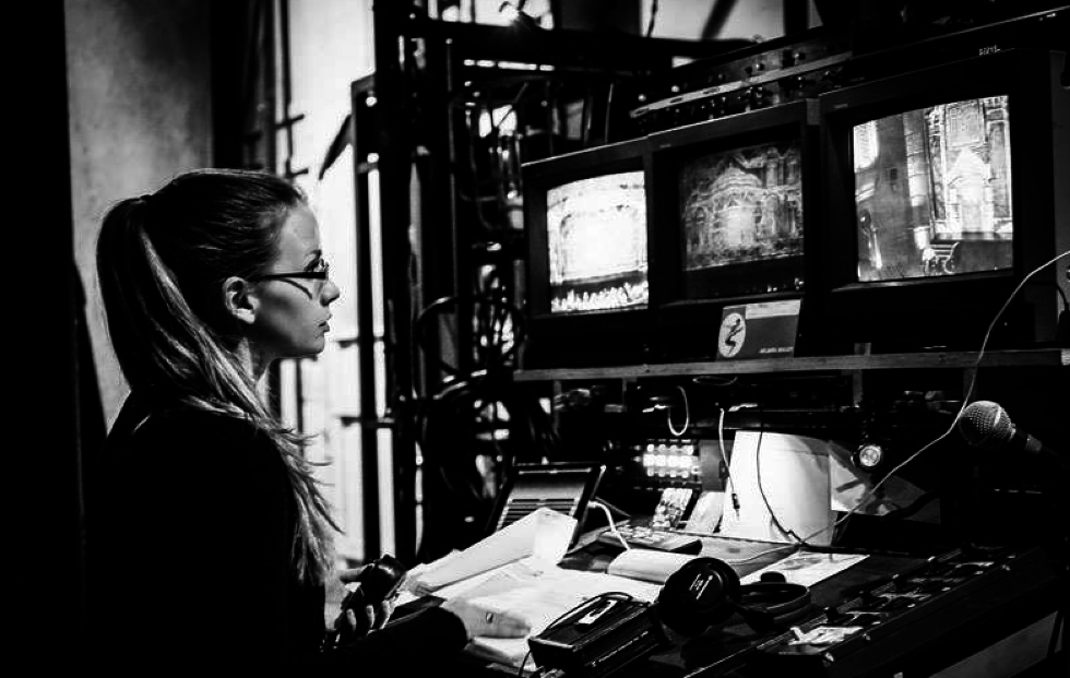 Kelly Brown sits backstage calling a show
