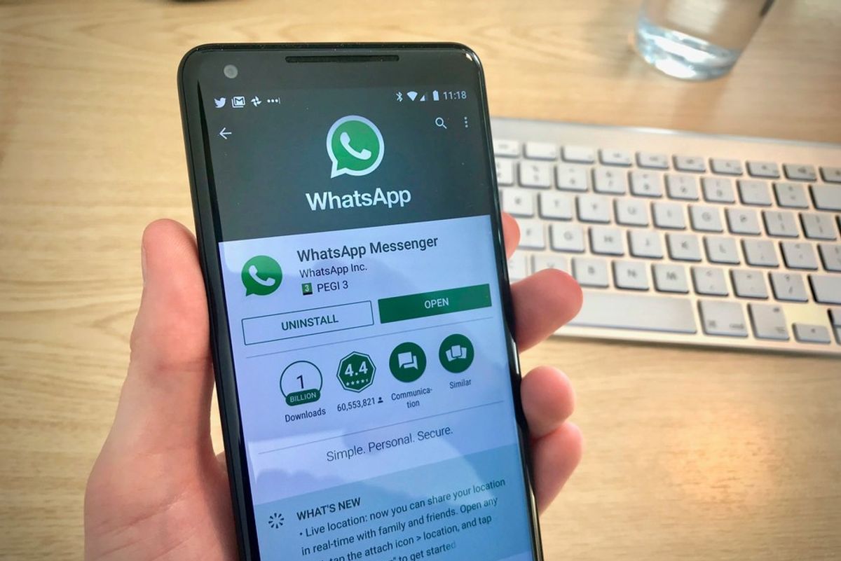 Photo of a smartphone installing WhatsApp