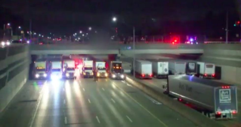 Trucks parked side by side on the freeway