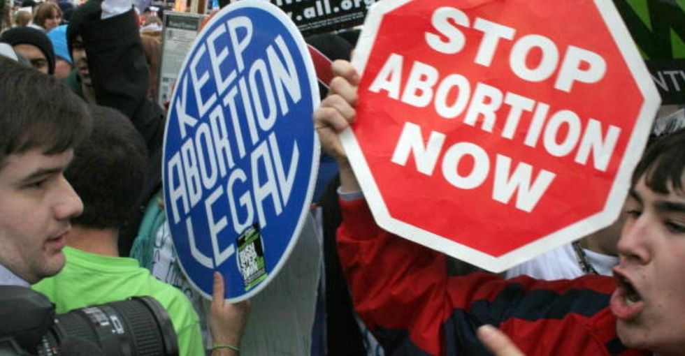 pro life and pro choice demonstrators face each other