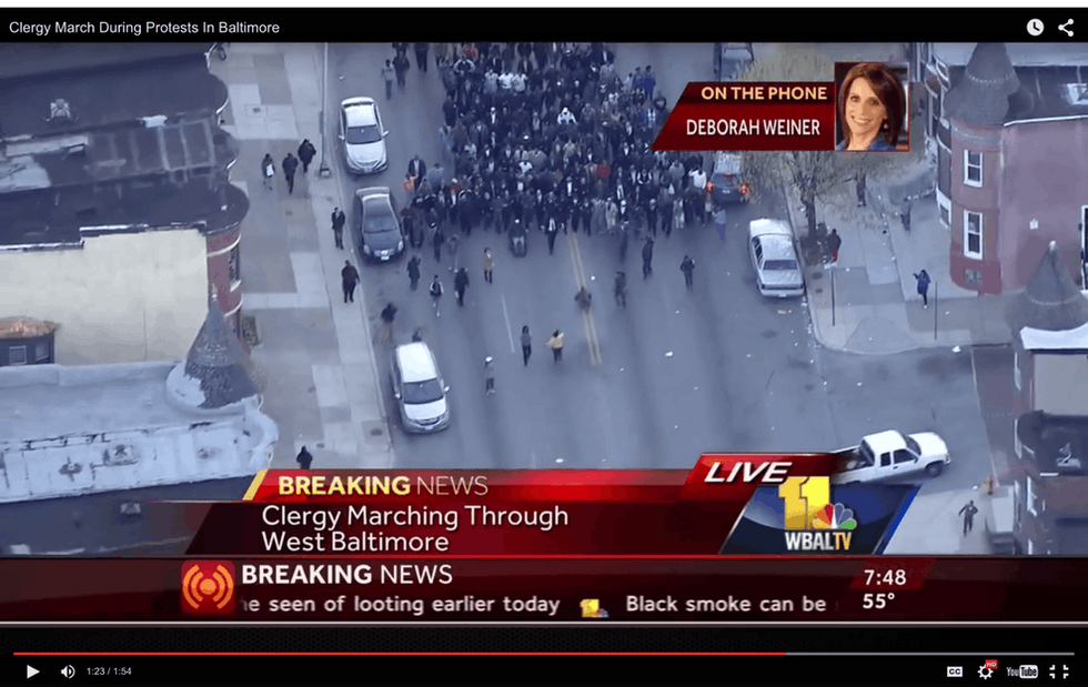 This powerful footage of over 100 clergy arm-in-arm through Baltimore shows the power of community.