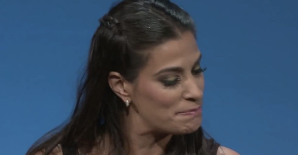 A gorgeous woman shakes her body on stage ... and the crowd goes wild.