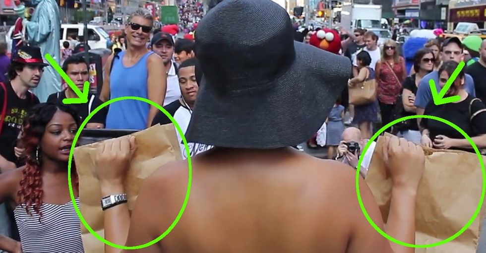 She stripped down to her underwear on a busy street and held up 2 bags. And everyone stared.