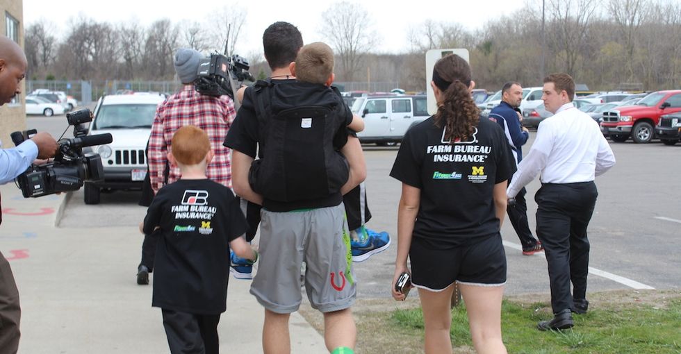 The amazing reason this kid carried his little brother on his back for 111 miles.