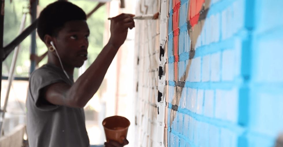 At the end, the camera zooms out and you see what these kids painted. Incredible.