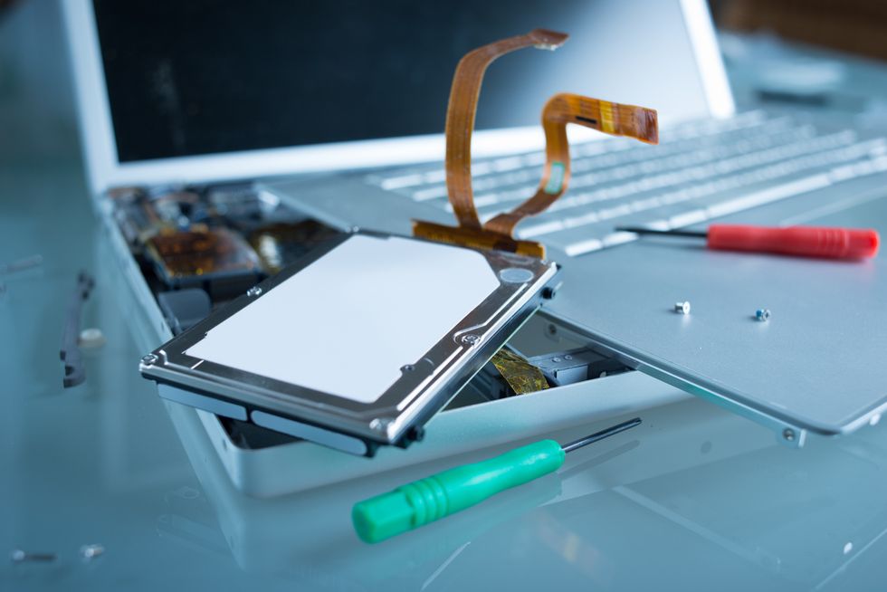 A photo of a computer and its drive, taken out, which people should make sure they completely wipe before selling