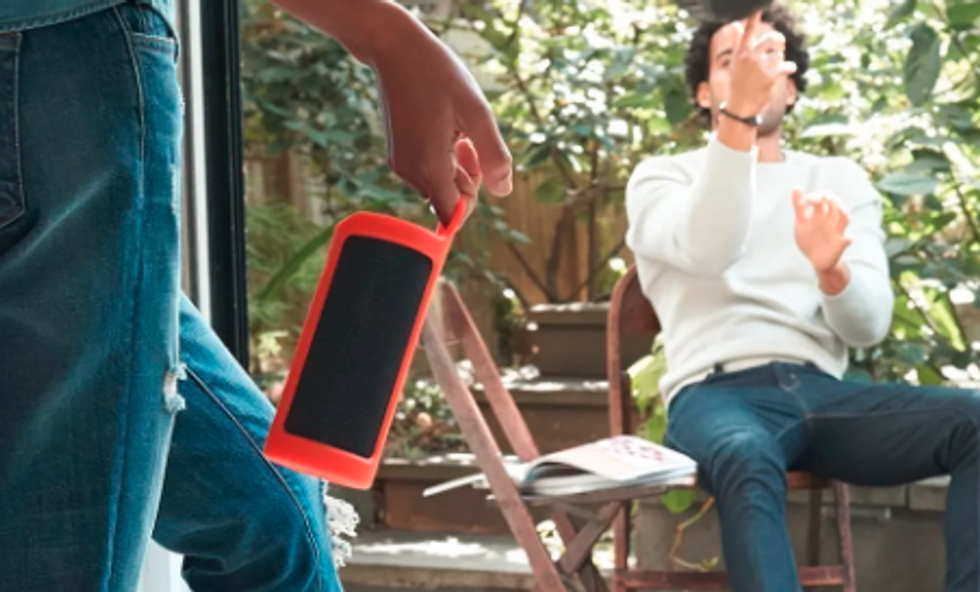 Photo of two men outside playing music on Amazon Echo Tap portable speaker
