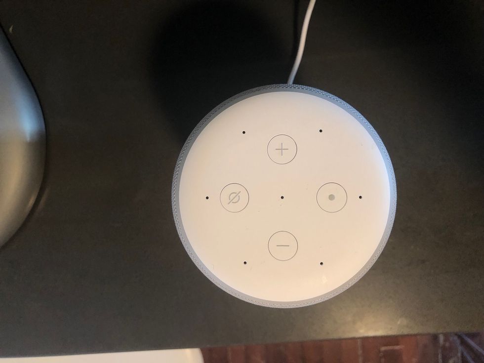 The top of the Echo Plus, pictured here, has familiar four buttons: volume up and down, power and one that turns off the listening feature