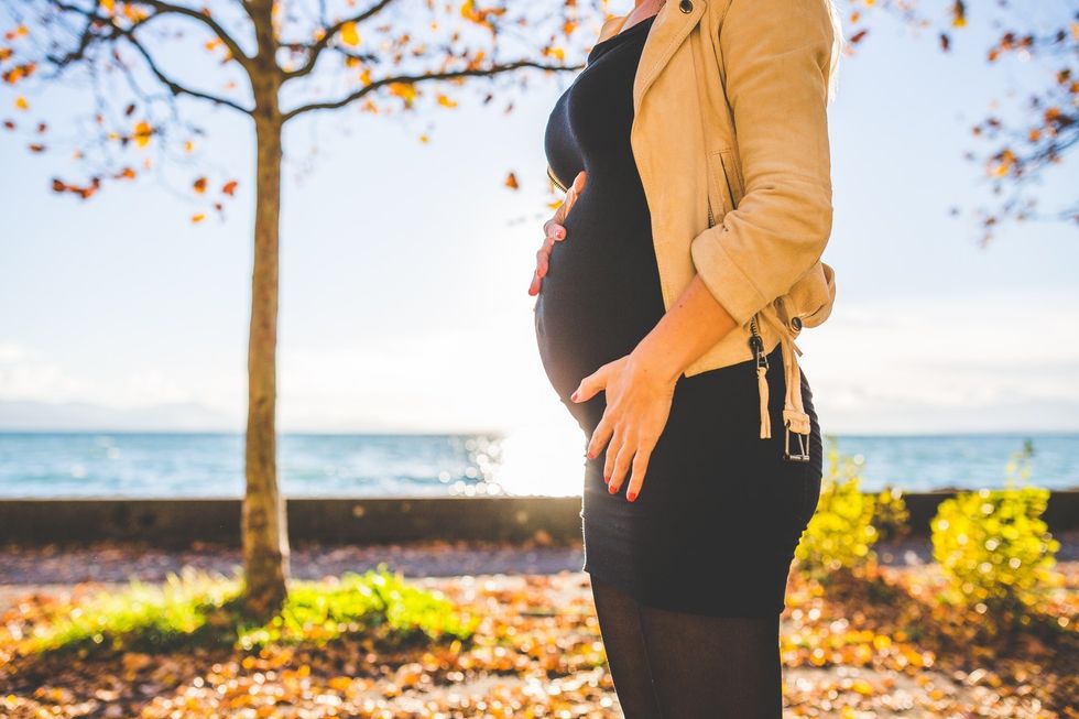 https://www.pexels.com/photo/pregnant-woman-wearing-beige-long-sleeve-shirt-standing-near-brown-tree-at-daytime-132730/
