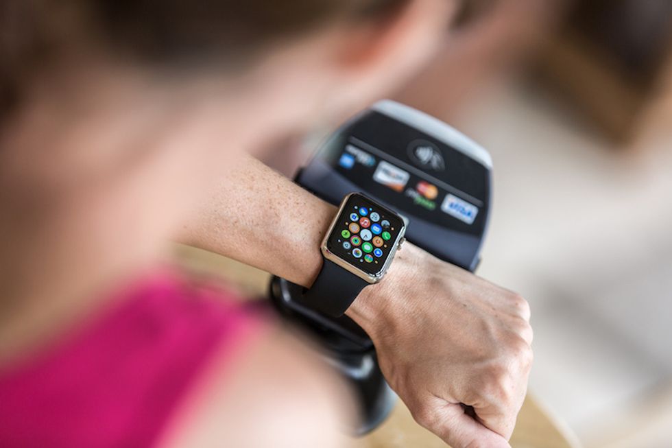 A photo of someone making a purchase with Apple Pay through the Apple Watch