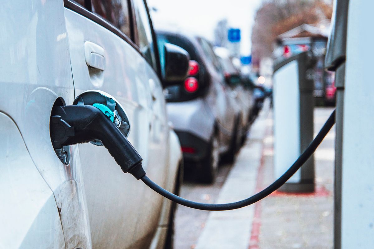 a photo of an electric car charging at a charging station.