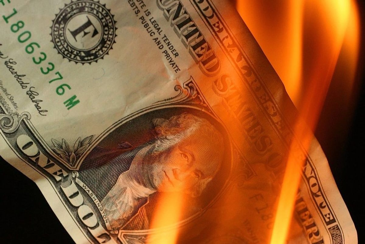 A burning one dollar bill