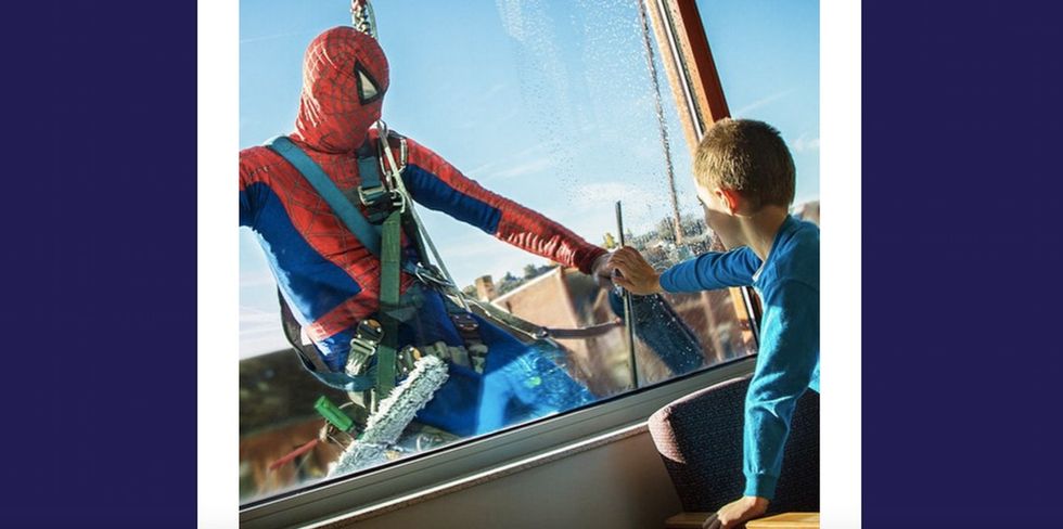 10 photos of superheroes washing windows and delighting children.