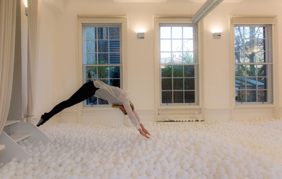 11 amazingly fun photos of adults playing in a ball pit, plus why science says play matters.