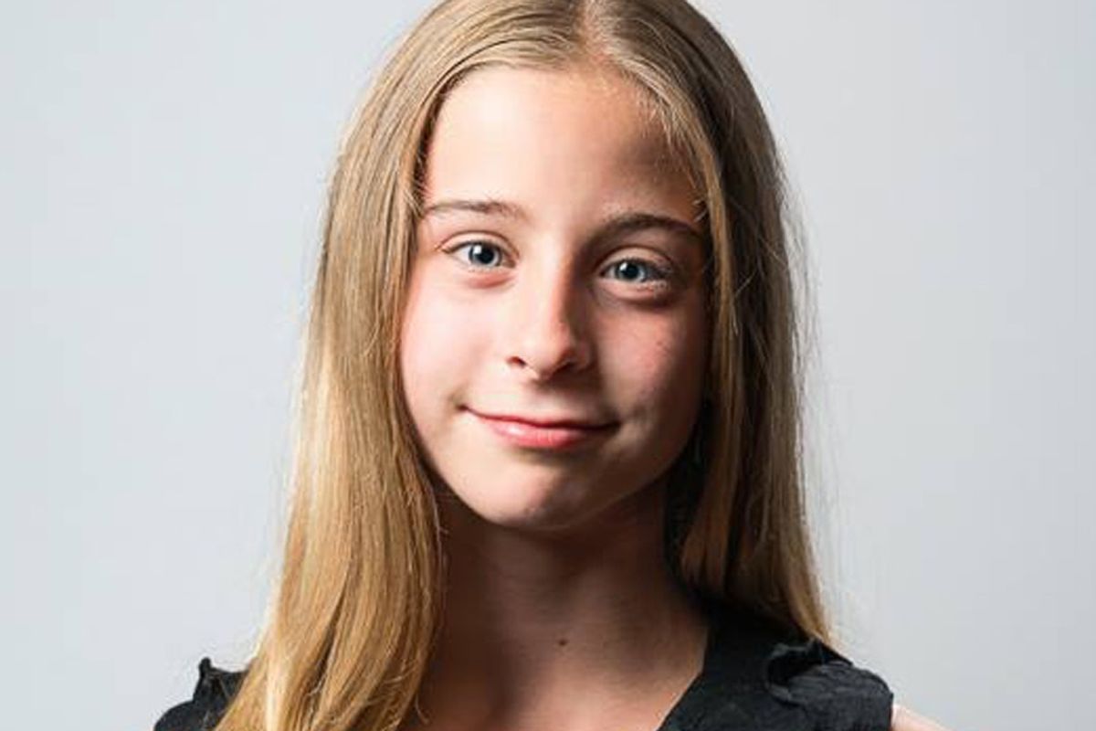 young blond girl smiles