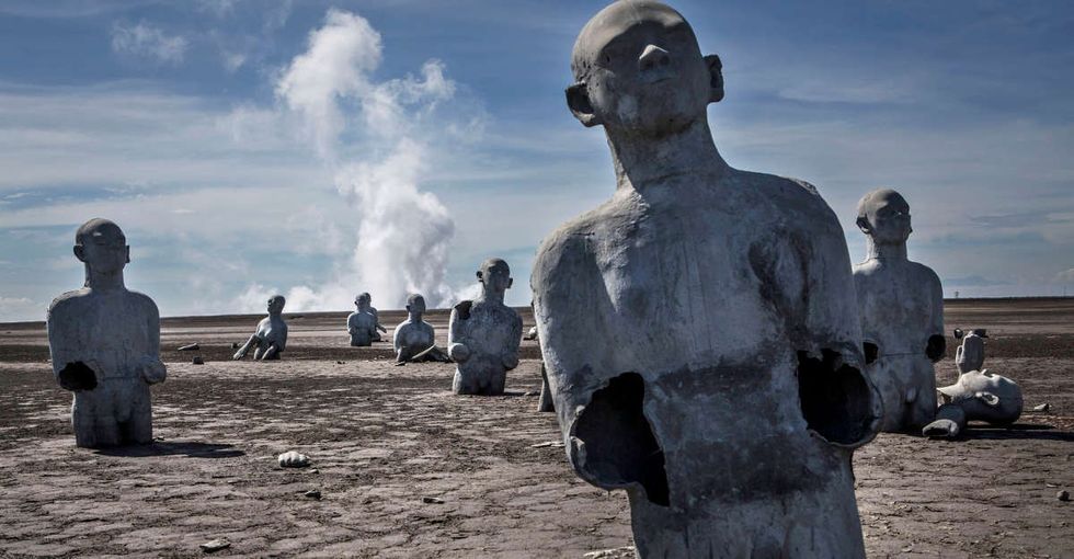 The haunting reason these sculptures were designed to sink slowly into the mud.