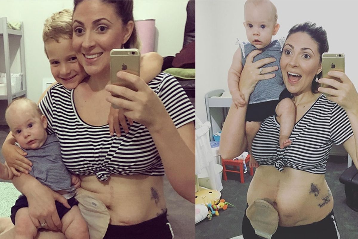 a mother poses for pictures in the mirror with her two children