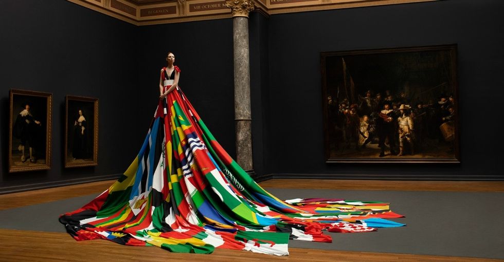 Trans model stuns in dress made from flags of countries where being LGBTQ is illegal.