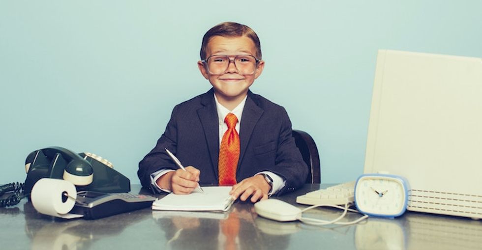 child pretends to be a business man