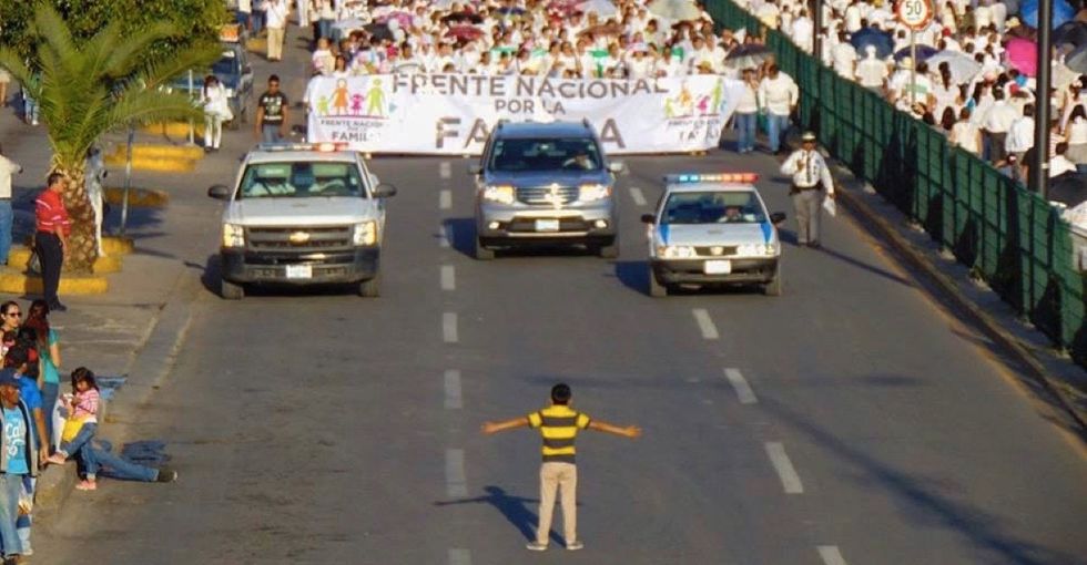This amazing photo of a boy at an anti-gay march went viral for all the right reasons.