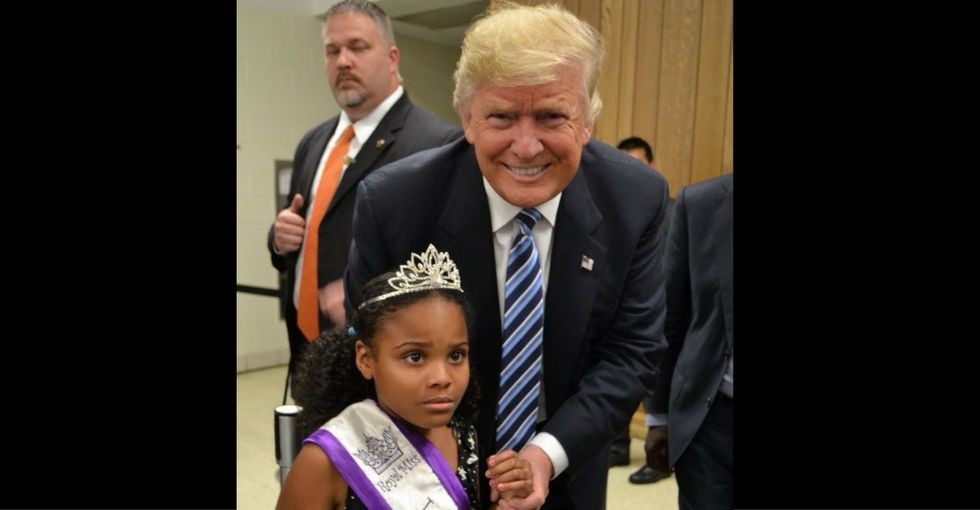 The true story behind that viral photo of Trump and 'Little Miss Flint.'