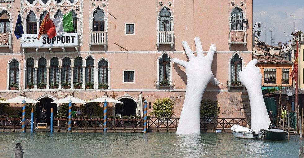 A pair of god-like hands emerged from a Venice canal. Here's how they got there.