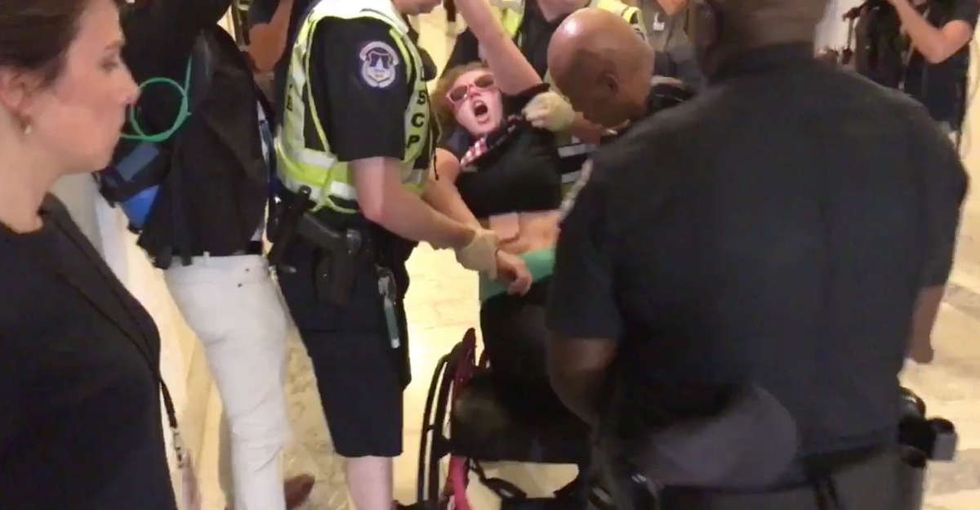 A woman dragged from her wheelchair for protesting the health care bill speaks out.