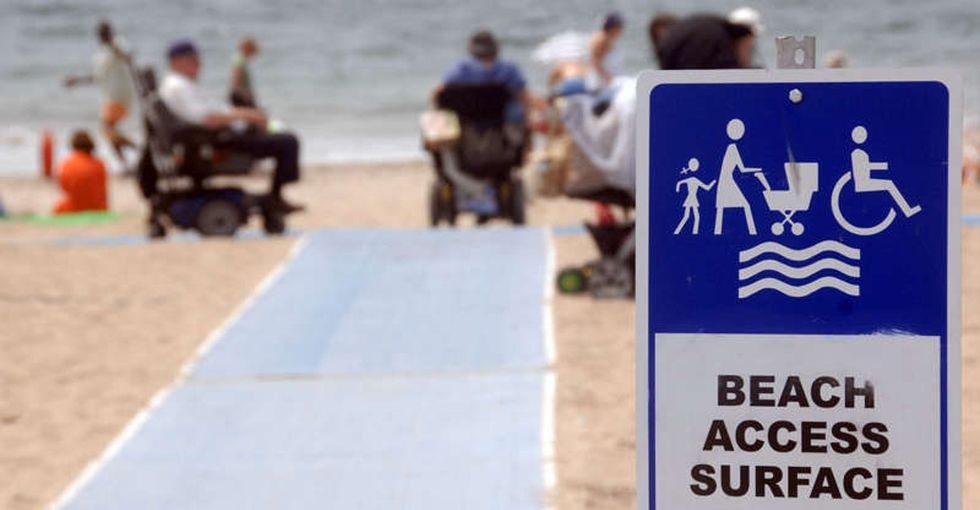 She fought to get a mat on the sand so her wheels could take her to the sea.
