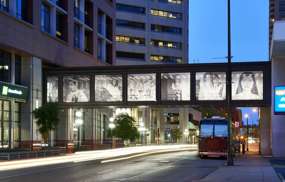 An artist gathered immigrants' photos and stories then hung them for the city to see.