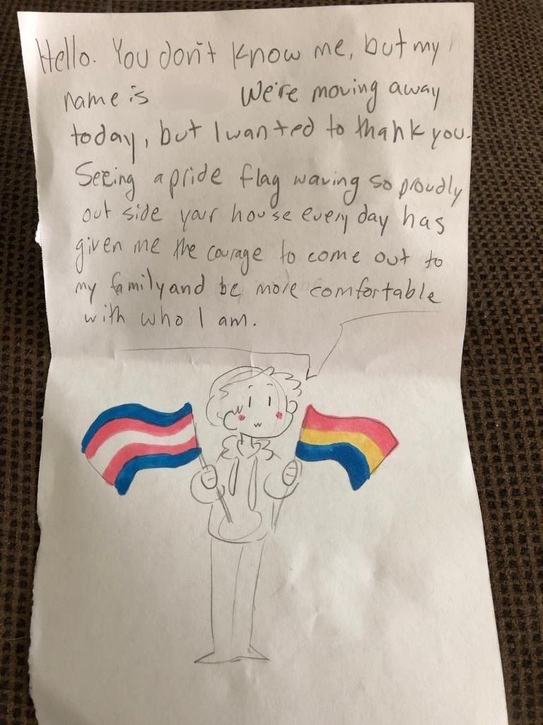 A gay couple's pride flag helped give a young teen the courage to come out to their family.