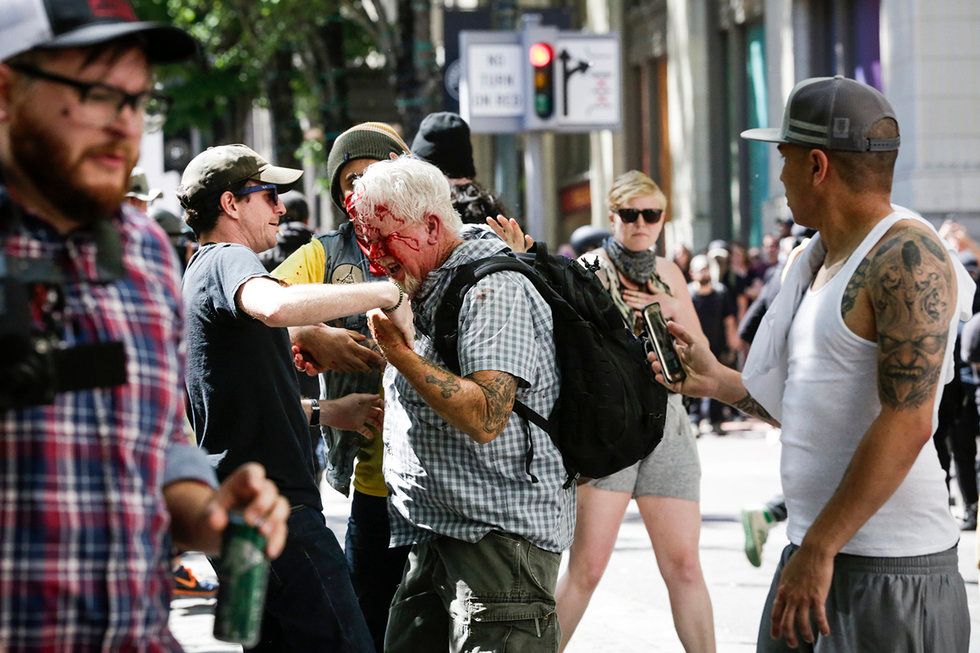 The Rose City Antifa brutally attacks an unidentified right aligning man at Pioneer Courthouse Square on June 29, 2019 in Portland, Oregon. Several groups from the left and right clashed after competing demonstrations at Pioneer Square, Chapman Square, and Waterfront Park spilled into the streets. According to police, medics treated eight people and three people were arrested during the demonstrations.